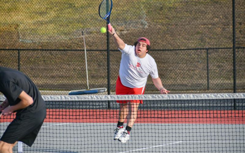 Wade Cheek/The Clayton Tribune. Senior Wildcat Talan Adams goes for the smash on the home courts.