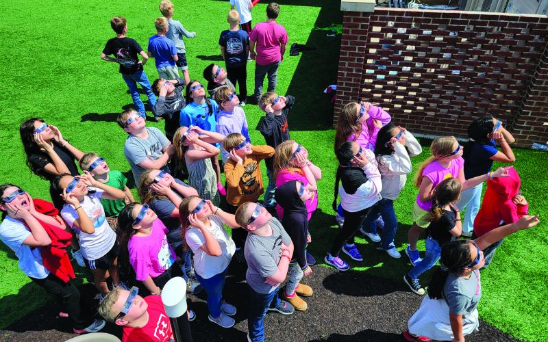 Enoch Autry/The Clayton Tribune. Wearing the eclipse shades, Rabun County Elementary School students gaze toward the sky during Monday’s solar eclipse. Left: Hudson Hamby sees the Eclipse in the sky Monday.