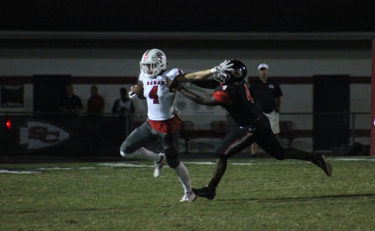 Rabun County wide receiver Braxton Hicks, left, stiff-arms Stephens County tight end Kenny Davis during the first half in Toccoa last Friday night. (Glendon Poe/The Clayton Tribune)
