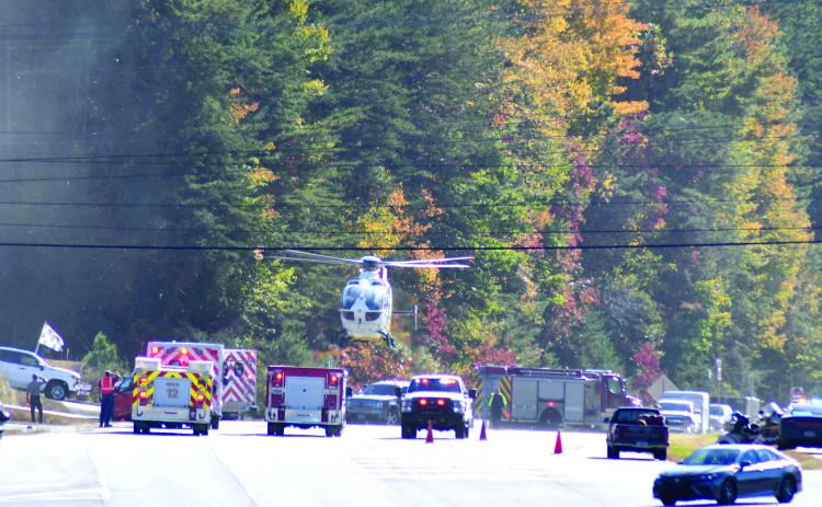 Enoch Autry/The Clayton Tribune. A helicopter lands on Georgia 15 at Seed Tick Road in Clayton Oct. 21 and emergency personnel work the scene following a crash involving a vehicle and motorcycle.