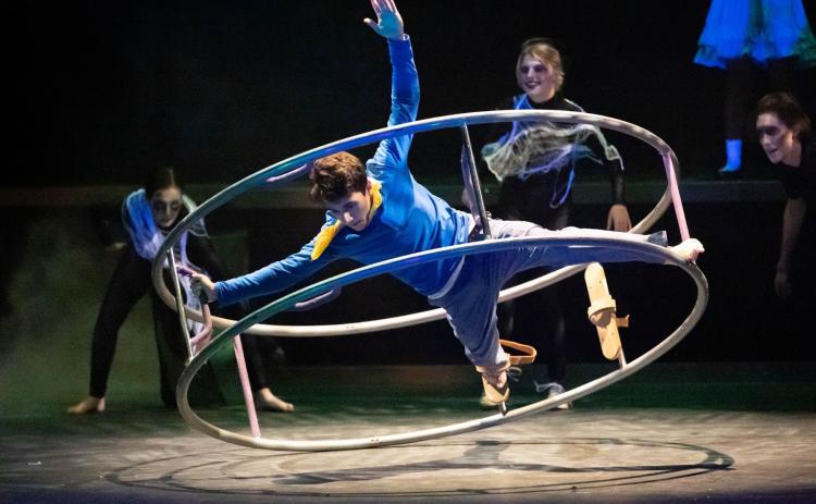 Photo courtesy Megan Morris/Rabun Gap-Nachoochee School. Cyrus Manoogian’24 of Rabun Gap, as Brian Dunning in Cirque Fantôme performs on the German wheel. Pictured in background, from left, are Juliette Teutsch ’24 of Demorest, Zoey Townsend ’23 of Cullowhee, N.C., and Parker Stribling’24 of Sautee Nacoochee, Ga. 