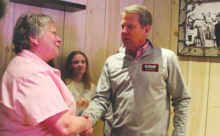 Megan Broome/The Clayton Tribune. Bonnie Edmonds of the Clayton Cafe shakes the hand of Gov. Brian Kemp during his campaign stop to Clayton in February.