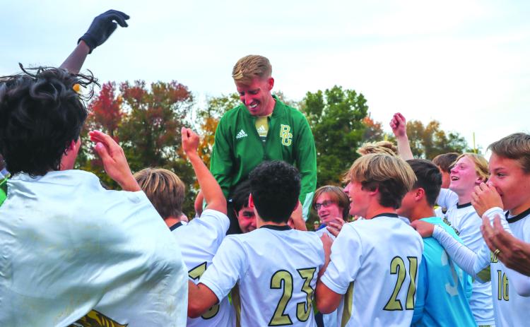 Courtesy of Chelsea Drabik. First year head coach Andrew Wiese is lifted on the team’s shoulders after leading the Eagles to their second straight state title.