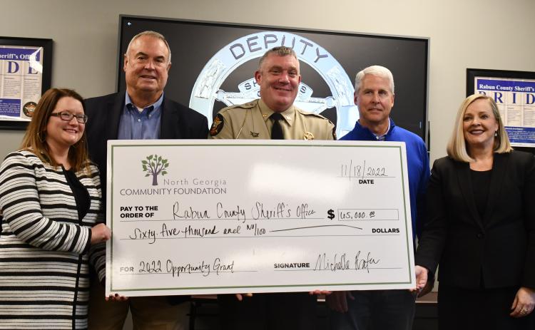 Megan Broome/The Clayton Tribune. Rabun County Commissioner Kent Woerner, Sheriff Chad Nichols and Rep. Stan Gunter are presented with the 2022 Opportunity Grant from the North Georgia Community Foundation by Abigail Carter, director of strategic initiatives for the North Georgia Community Foundation, and Michelle Prater, president and CEO of the North Georgia Community Foundation. The $65,000 check was presented at the Rabun County Sheriff’s Office Nov. 18. 