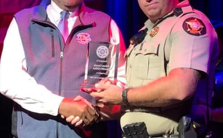Photo from RCSO Facebook page. Deputy Matt Chaney leads the Selective Traffic Enforcement Program (S.T.E.P.) Unit in Rabun County. He accepts the Georgia Governor’s Office of Highway Safety Northeast Traffic Enforcement Network Agency of the Year award on behalf of the Rabun County Sheriff’s Office recently. 