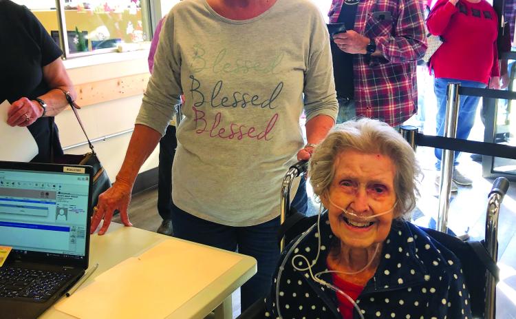 Photo courtesy of Sandra Wood. At 101 years old, Mildred Widgery casts her ballot for the Dec. 6 runoff U.S. Senate race election during early voting Nov. 30 with help from daughter-in-law Sandy Widgery.  