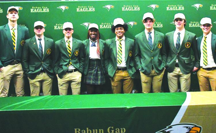 Luke Morey/The Clayton Tribune. On Wednesday, Dec. 7, eight Rabun Gap-Nacoochee School seniors signed their Letters of Intent to play at the collegiate level. From left, Domas Kauzonas (University of North Carolina Greensboro); Brody Roulier (Missouri S&T); Lewis Rodriguez (Marist); Calea Jackson (University of Miami): Armani Guzman (West Virginia); Nickolas Roy (University of Buffalo); Dylan Alonso (Middle Tennesee State) and Luke Earnhardt (Middle Tennessee State). 