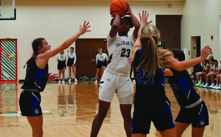 Luke Morey/The Clayton Tribune. Senior Denika Lightbourne goes up for a shot against two Lake Oconee defenders on Wendesday, Dec. 7. The Lady Indians are on a six-game losing streak.