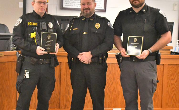 Megan Broome/The Clayton Tribune. Clayton Police Department Chief Andy Strait (center) presents Officer Jimmy Nations (left) with an award for Outstanding Officer for the Third Quarter 2022 and Sgt. William Wall with an award for Outstanding Officer for the Fourth Quarter 2022, during a presentation at the Jan. 17 Clayton City Council meeting. 