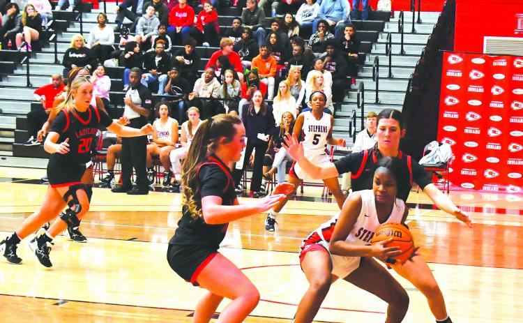 Luke Morey/The Clayton Tribune. With Rabun County High School Lady Cat junior Ellie Southards in the background, junior Mili Watts (middle) and senior Mary Lovell trap Stephens County’s Jaziya Harbin in the first quarter of a 56-26 victory. The Lady Cats now are 14-1 with region games up next.
