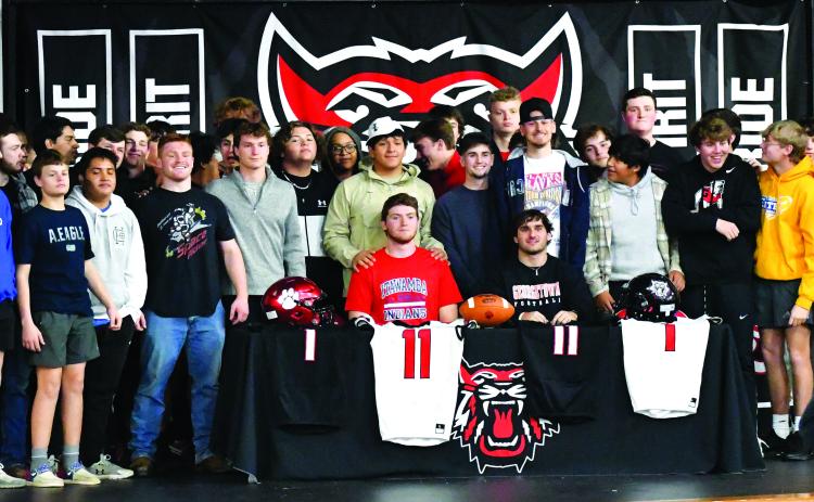 Luke Morey/The Clayton Tribune. Joined by their football teammates, Rabun County seniors Keegan Stover (seated left) and Nicholas Baloga signed to play at the college level on Wednesday, Feb. 1. Stover and Baloga both led Rabun County to a 12-1 record in the senior season.