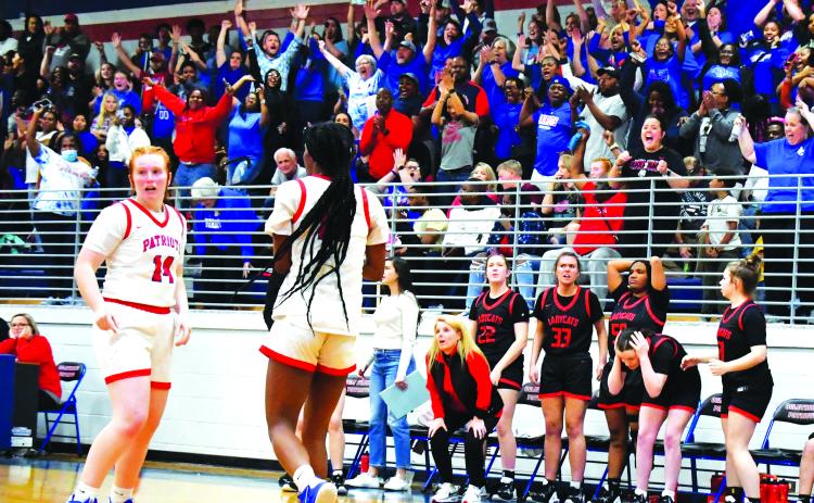 Luke Morey/The Clayton Tribune. With a jubilant Oglethorpe crowd behind them, Rabun County head coach DeeDee Dillard and the Lady Cat bench react to a last second travel call on Friday, Feb. 24. The Lady Cats lost to Oglethorpe County 51-50, ending their season in the Sweet Sixteen.