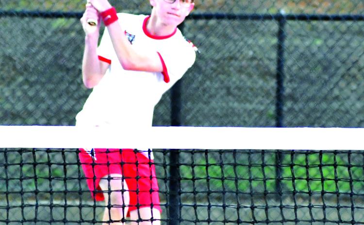 Luke Morey/The Clayton Tribune. RCHS No. 1 singles player Robbie Fountain returns a shot against Franklin, N.C., on Tuesday, Feb. 28, for the boys’ second win of the season. Fountain won 7-6 (5), 6-3 to help the Wildcats to a 3-2 victory. 