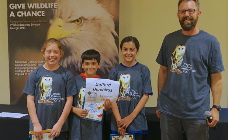 Photo courtesy of Chris May. Youth birding competition coordinator Tim Keyes poses with the Bufford Bluebirds team. For the first time in three years, the birding competition has returned, with the deadline for signups March 31.