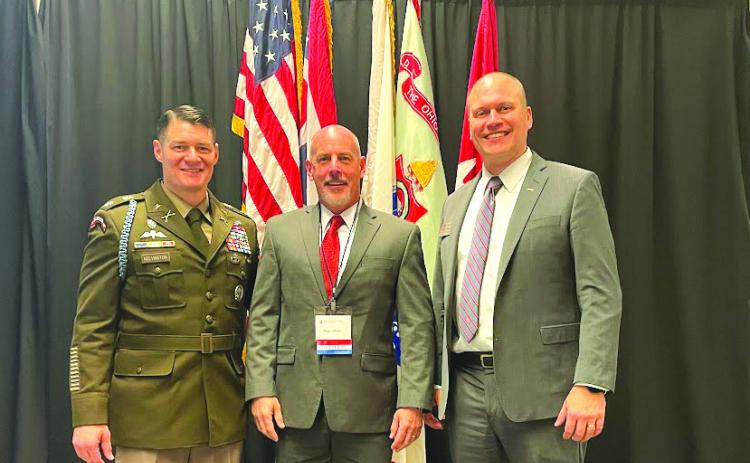 Photo courtesy Roger Glenn. Roger Glenn (center) stands with Lt. Col. Michael Kelvington, professor of military science, and Doug Huber, the current president of The Ohio State Army ROTC Alumni Society, at Glenn’s induction ceremony into the university’s ROTC hall of fame.
