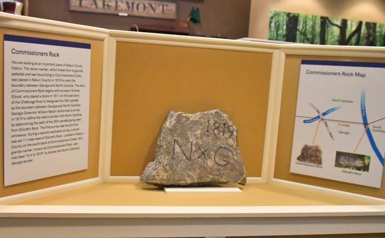 Megan Broome/The Clayton Tribune. Commissioners Rock, which depicts a surveying monument marking the boundary between Georgia and North Carolina dating back to 1819, is now on display at the Rabun County Historical Society. 