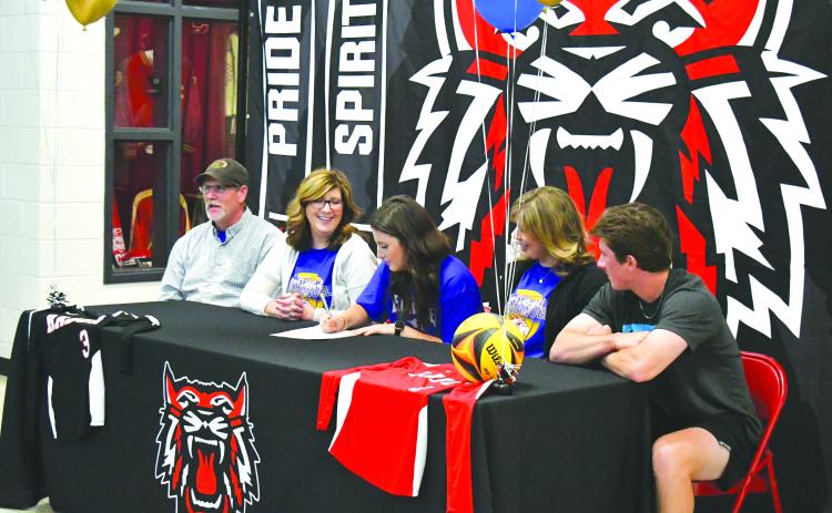 Luke Morey/The Clayton Tribune. On Monday, April 24, RCHS senior Abbye Carver signed her collegiate letter to play beach volleyball at Emmanuel College. Pictured from left, father Jim Carver, mother Tori Carver, Abbye, sister Miranda Hunnicutt and brother Grayson Carver. 