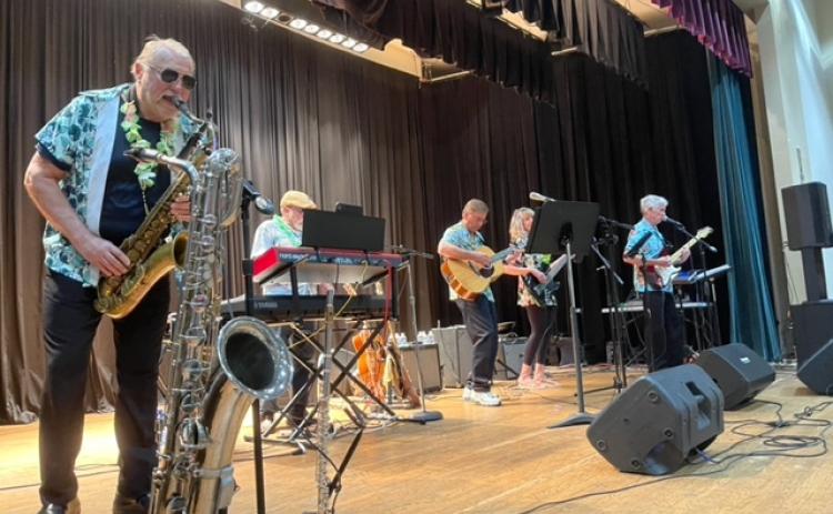 Submitted photo. The band Sweet Charity with guest musician Greg Funkhouser performs at the Clayton Rotary Club Foundation’s Luau fundraising event April 22.