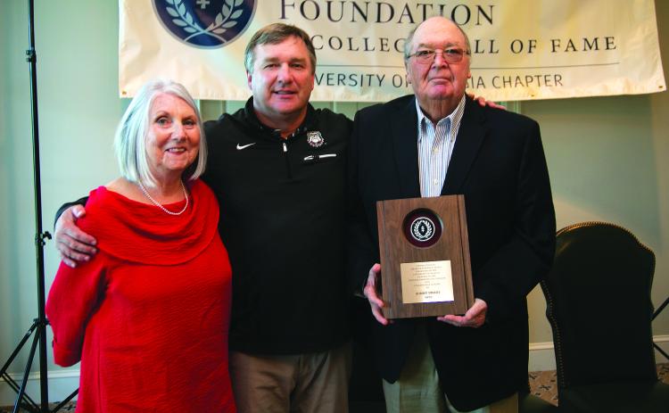 Submitted photo. Standing with his wife Sharon, Sonny Smart (far right) receives the Contribution to Amateur Football Award. A Rabun County resident, Smart is the father of current University of Georgia head football coach Kirby Smart (center). Among his career stops, Smart was the head football coach and athletic director at Rabun County High School.