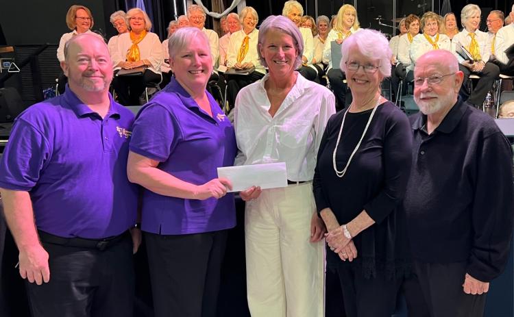 Submitted photo. Linda Sterrett, Brasstown Ringers director, presents a check for $1,200 raised for F.A.I.T.H. at the benefit concert in Clayton on April 29. Pictured are George James, Clayton First United Methodist Church; Linda Sterrett, Brasstown Ringers Director; Sarah Charity, F.A.I.T.H. Director; Beverly Barnett, Mountain Voices Director; and Graham Bethel, Pinnacle Brass Director.  
