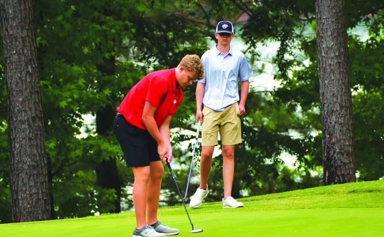 Luke Morey/The Clayton Tribune. RCHS top finisher Jack Hood lines up a putt at the state golf championship on Tuesday in Elberton. 