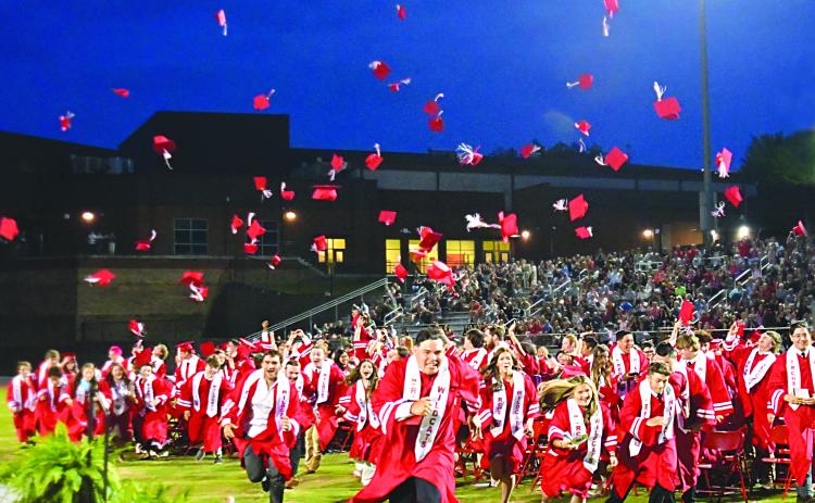 Enoch Autry/The Clayton Tribune. After Rabun County High School Principal Justin Spillers announces the Class of 2023 are graduates, the student body rush to ring the bell at Frank Snyder Memorial Stadium. 