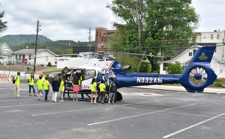 Megan Broome/The Clayton Tribune. Air Life personnel talk to students about what they do and allow them to see the inside of the helicopter first-hand.