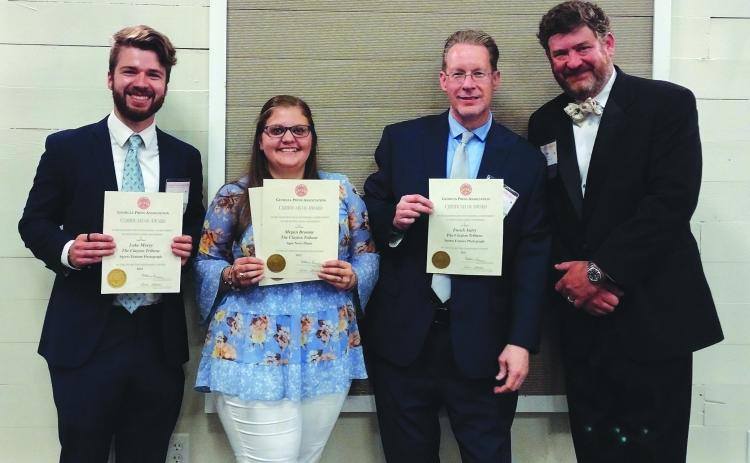 Photo courtesy Conner Horn. Holding their Georgia Press Association awards, The Clayton Tribune staff members Luke Morey, Megan Broome and Enoch Autry stand next to Community Newspapers, Inc., Chairman Alan NeSmith on June 9.