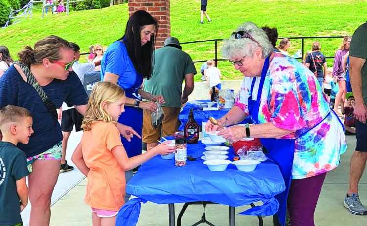 Megan Broome/The Clayton Tribune. Children enjoy an Ice Cream Sundae party at the Rabun County Public Library May 31 to kick off this year’s Summer Reading Program theme “All Together Now.” 