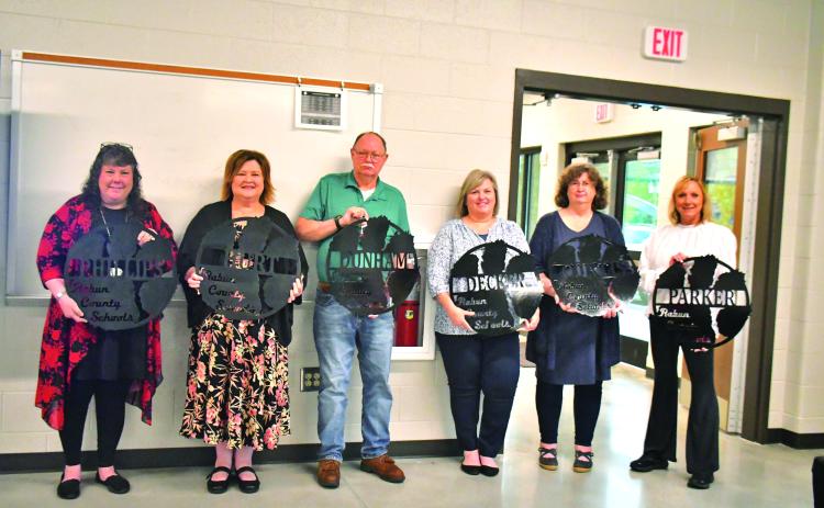 Megan Broome/The Clayton Tribune. Retiring employees at Rabun County Schools were recognized May 18 at the Agri-Science Center and given a gift made by Rabun County students in mechanics class. Pictured are Diane Phillips, RCES teacher (left); Pam Hurt, RCPS music teacher; James Dunham, RCMS custodian; Audrey Decker, RCES nurse; Kelley Curtis, RCES teacher; and Lora Parker, RCES paraprofessional. Not pictured are Memorio Cruz, RCHS custodian; Phil Sidey, RCHS paraprofessional; and Dowana Hopper, bus driver.