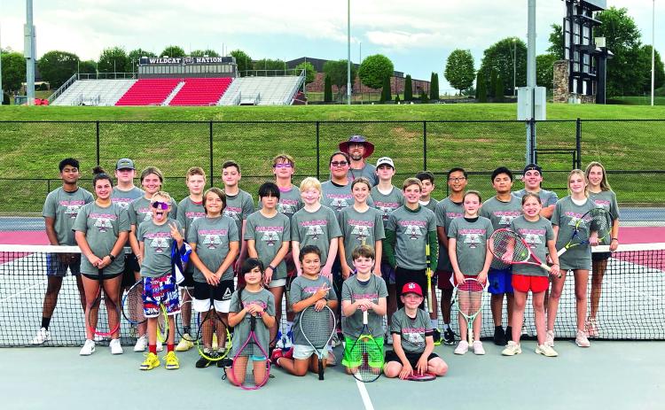 Photo courtesy Bryan Getty. Getty and Wildcat tennis athletes pose with their campers from the Wildcat Tennis Academy