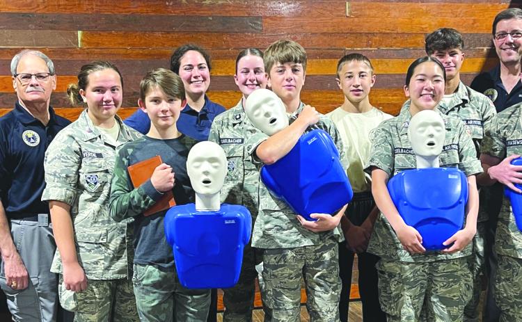 Photo courtesy Melissa Elzey. Civil Air Patrol Currahee Squadron completes American Heart Association Basic First Aid and CPR Certification. Pictured from left to right are Capt. Trampes Stancil; 1Lt Russ Conner; C/SrA Erica Verde; C/AB Jaden Shurtliff; SM Erin St Clair; C/2Lt Lucy Vogelbacher; C/A1C Donovan Biagioni; C/SrA Spencer Verde; C/SMSgt Stella Vogelbacher; C/SrA Julian Mulholland; Lt. Col. Eric Vogelbacher; C/SrA Cade Klimasewski; and Lt. Col. Steven St. Clair. 