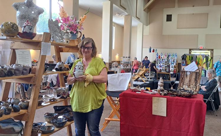 Megan Broome/The Clayton Tribune. Amy Lovelady Strickland with Lovelady Creations showcases her pottery at the Painted Fern Art Festival in Clayton last weekend. Strickland took home the Best in Show Peoples’ Choice Award for her pottery. 