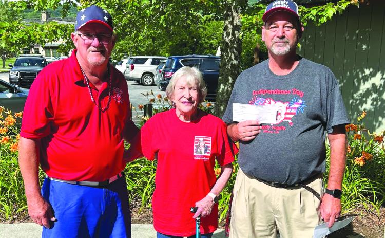 Submitted photo. Jeff Harris (far right) from Piggly Wiggly presents Sid Weber Memorial Cancer Fund (SWMCF) with a check for $2,500 at the BBQ in Sky Valley on July 3. It is a portion of the proceeds from the store’s Customer Appreciation Day. Pictured with Harris are SWMCF President Ken Walton and Barbara Weber.  
