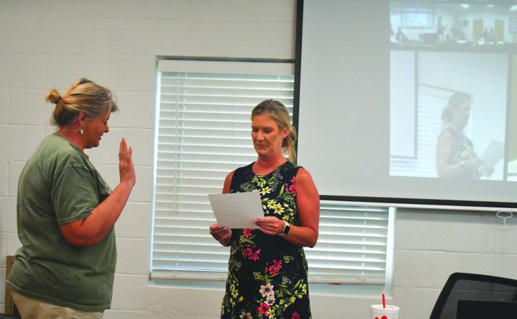 Megan Broome/The Clayton Tribune. Tallulah Falls Town Clerk Linda Lapeyrouse gives newly appointed Council Member Cissy Henry the oath of office as she is sworn in during the town council meeting Aug. 16. Henry fills the seat left vacant by Tom Tilley until a Nov. 7 special election.