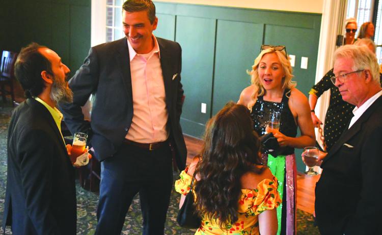 Enoch Autry/The Clayton Tribune. Mehran Ebadolahi (from left) talks with Rabun Gap-Nacoochee Head of School Jeff Miles as Andrea Sorgeloos and Keith Sorgeloos talk to guests at the Green & Gold Gala in the Woodruff Dining Hall.