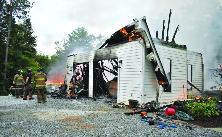 Megan Horn/The Clayton Tribune. Rabun County firefighters battle a structure fire on Sidetrack Lane on Aug. 27. 