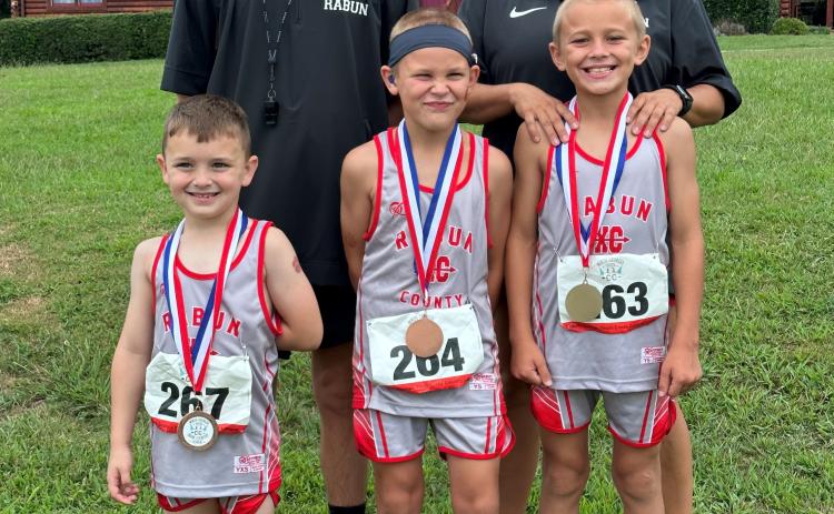 Submitted photo. Three top-10 medalists stand along with coaches Jinny Hanifan-Wagner and Ed Eidson. Pictured with the coaches are Owen Moseley, 8U boys (from left); Keegan Hanifan-Wagner, 8U boys; and Kai Hanifan-Wagner 10U boys.