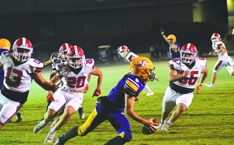 Wade Cheek/The Clayton Tribune. Athens Christian QB Matt Wiggins tries to avoid the Wildcats’ rush on Oct. 20 in a region contest won by RCHS 38-0. The Wildcats, who play Commerce this week, held the Eagles to negative 7 yards total offense. 
