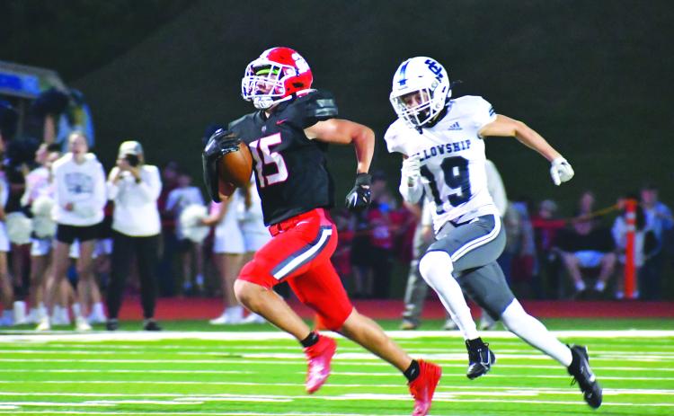 Wade Cheek/The Clayton Tribune. Wildcat sophomore running back Reid Giles wins a 64-yard foot race to score RCHS’s first touchdown in Sept. 29’s 42-28 victory of Fellowship Christian School. The Wildcats ran for a school-record 411 yards.