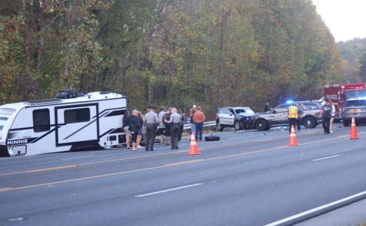 Thomas Sherrill/The Franklin Press. Emergency personnel from North Carolina work the scene of a four-vehicle crash with one fatality and other injuries on Georgia Road in Otto, N.C., Friday, Oct. 20. The scene left extensive damage on the roadway. The North Carolina State Highway Patrol is investigating the crash that caused traffic to back up as the road was closed for over four hours. 