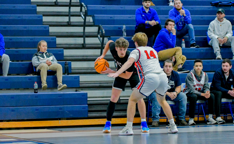 Wade Cheek/The Clayton Tribune. Senior forward Cooper Welch sizes up a West Oak defender during last Friday’s (Dec. 22) win over the Warriors. 