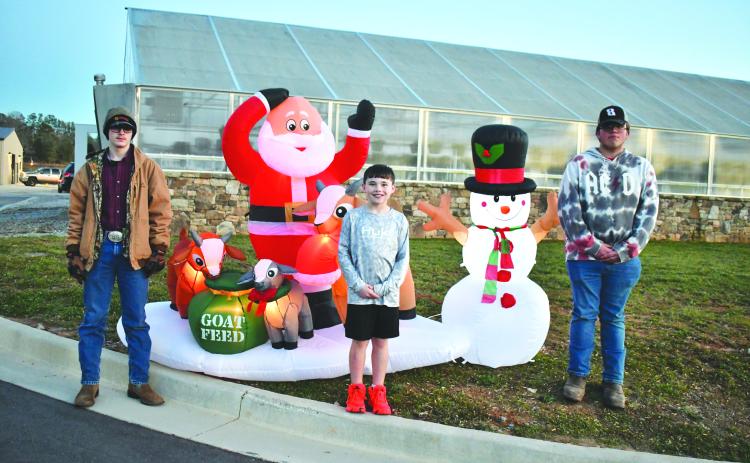 Megan Horn/The Clayton Tribune. FFA member Preston Patterson, Cayden McClain and FFA member Garrett Craig were among those who were in attendance at the Dec. 7 first-ever “Santa and Elves on the Farm” at the agricenter. 