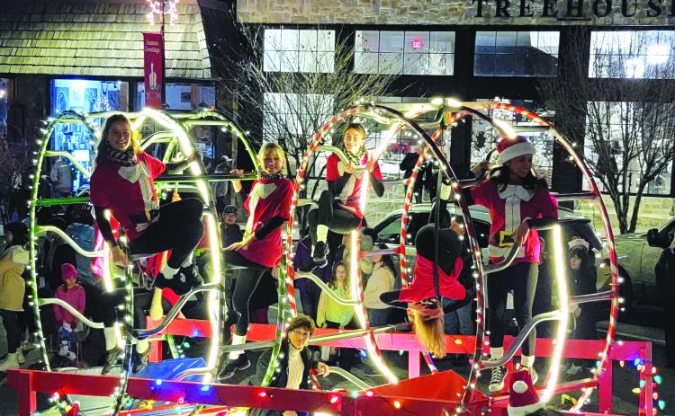 Enoch Autry/The Clayton Tribune. Rabun Gap-Nacoochee School students perform cirque maneuvers on their float in the Clayton Christmas Parade to help them win the “Best Overall” honors. The RGNS dance team also performed.