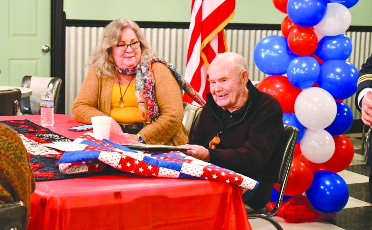 Megan Horn/The Clayton Tribune. WWII U.S. Navy veteran Lt. J.G., Dr. Eldred Causey smiles alongside his daughter Kathy Causey as he is recognized at the Vet to Vet Cafe Feb. 13 for turning 100 years old. He received gifts for his milestone birthday. 
