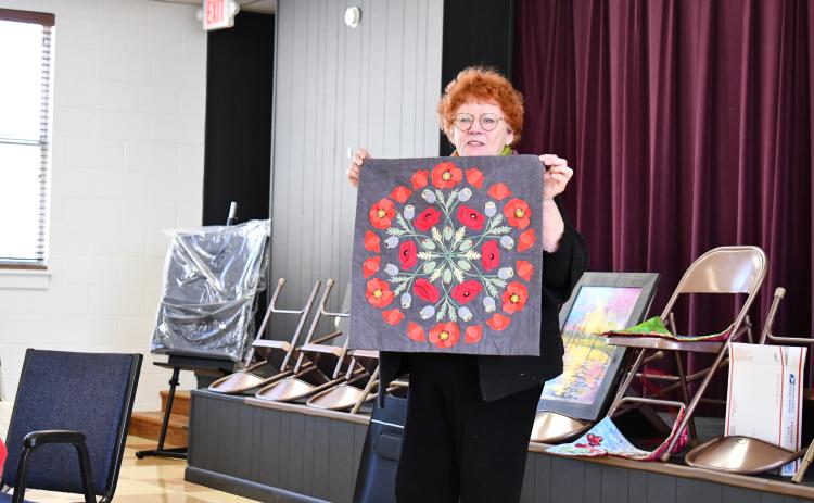 Megan Horn/The Clayton Tribune. Silke Cliatt showcases fabric art with a brightly colored Mandala made with slow hand stitching during the North Georgia Arts Guild “Show and Tell” showcase Feb. 15. Cliatt said the inspiration came from a Poppy flower. 
