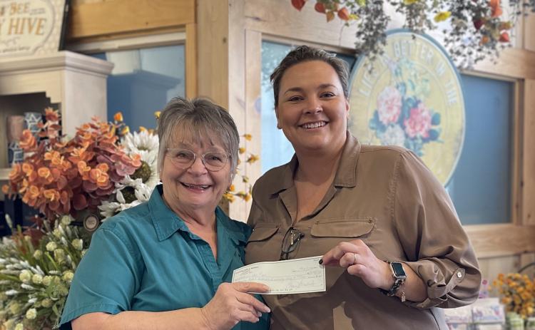 Submitted photo. Clayton Cafe Owner Bonnie Edmonds presents the donation check from the Feb. 19 Spaghetti Dinner ‘Raise a Fork for a Great Causes’ at Clayton Cafe & Market to Rabun Paws 4 Life Fundraising Chair Ara Joyce. The event raised $4,221 for the nonprofit. 